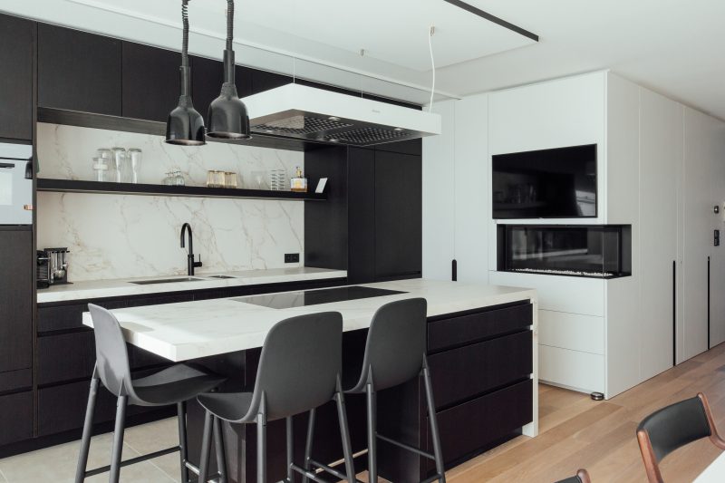 Centraal in deze interieurrenovatie staat de nieuwe keuken, een combinatie van donker en licht.